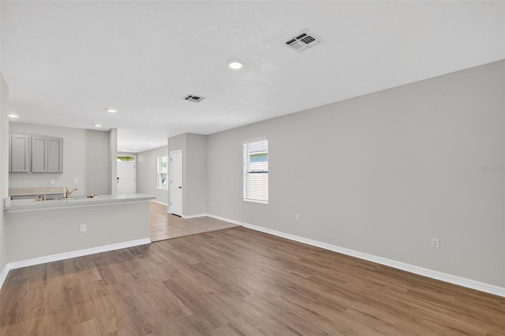 349 Honey Bell Road Winter Haven, FL 33880 - Photo 14 of 29 an empty room with wooden floor and windows
