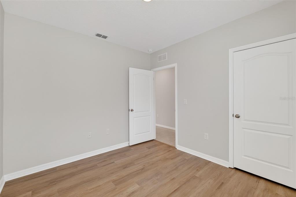 349 Honey Bell Road Winter Haven, FL 33880 - Photo 18 of 29 a view of an empty room with wooden floor