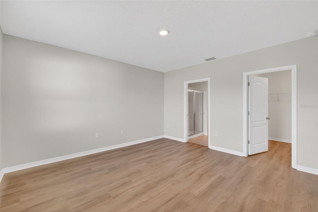349 Honey Bell Road Winter Haven, FL 33880 - Photo 20 of 29 a view of an empty room with wooden floor
