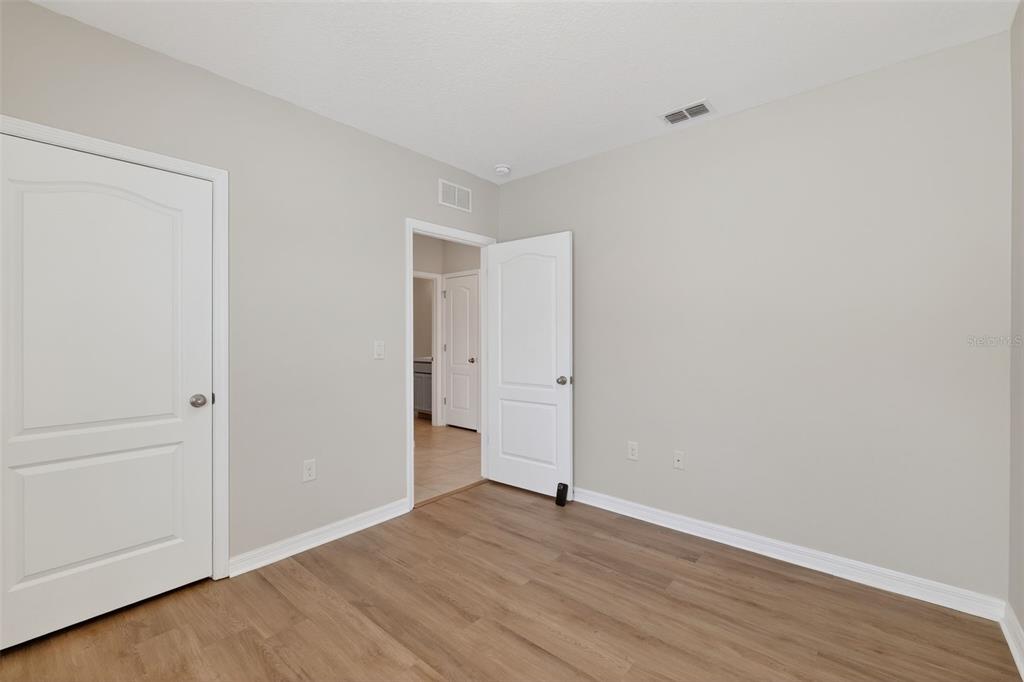 349 Honey Bell Road Winter Haven, FL 33880 - Photo 21 of 29 a view of an empty room with wooden floor