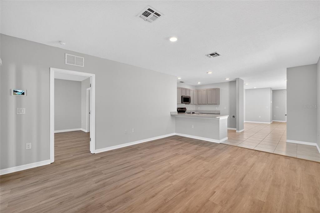 349 Honey Bell Road Winter Haven, FL 33880 - Photo 8 of 29 a view of kitchen with wooden floor