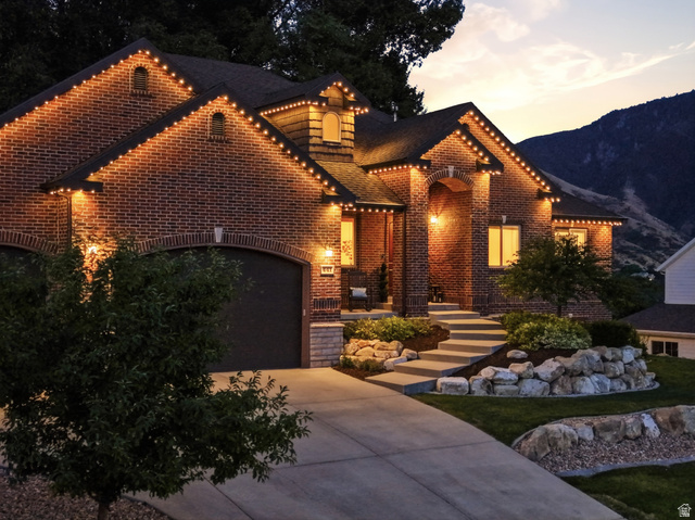 441 South 2080th Street East Springville, UT 84663 - Photo 62 of 64 Brick exterior with integrated garage, concrete driveway, and tiered landscaping