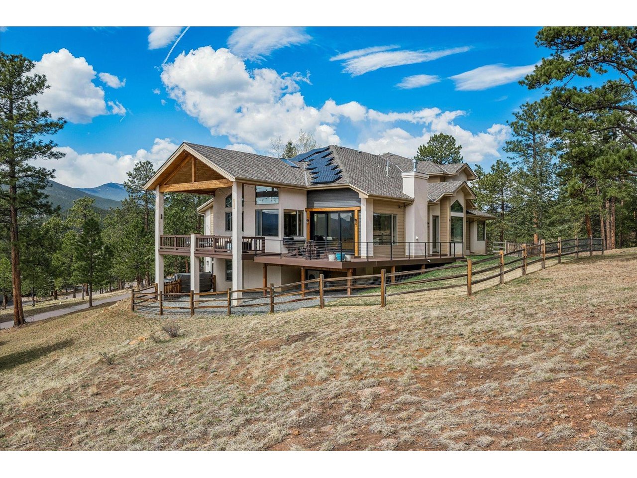 1424 Solitude Lane Evergreen, CO 80439 - Photo 1 of 46 a view of a house with a backyard