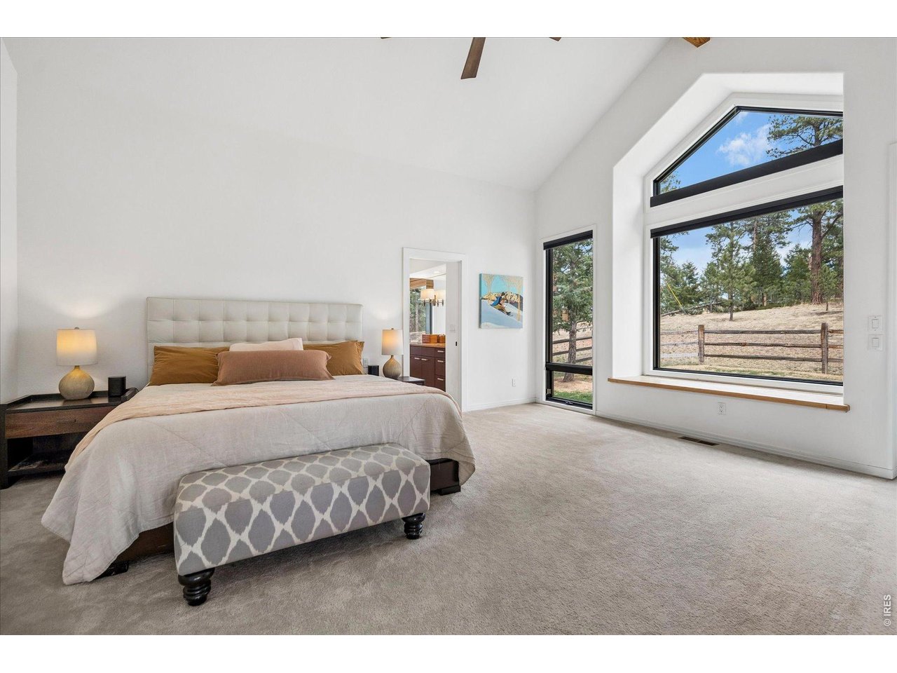 1424 Solitude Lane Evergreen, CO 80439 - Photo 17 of 46 a bedroom with a large bed and a large window