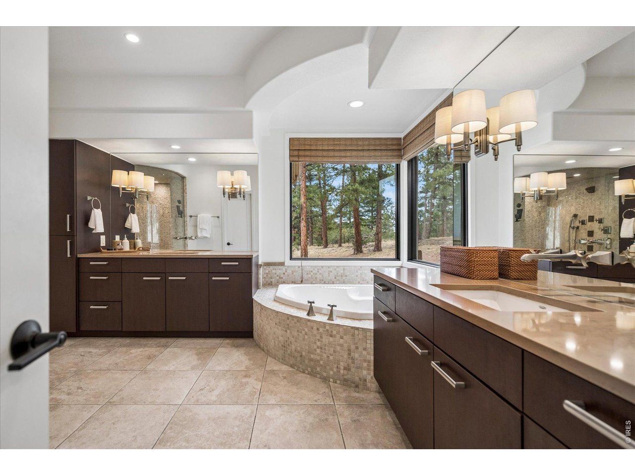 1424 Solitude Lane Evergreen, CO 80439 - Photo 19 of 46 a large bathroom with a tub sink and mirror