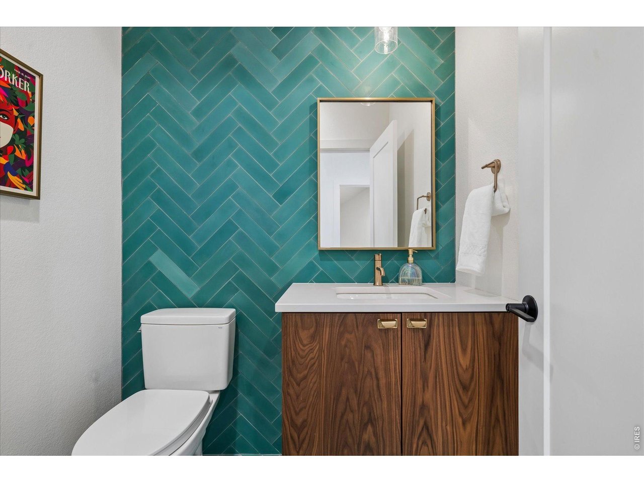 1424 Solitude Lane Evergreen, CO 80439 - Photo 21 of 46 a bathroom with a toilet sink and mirror