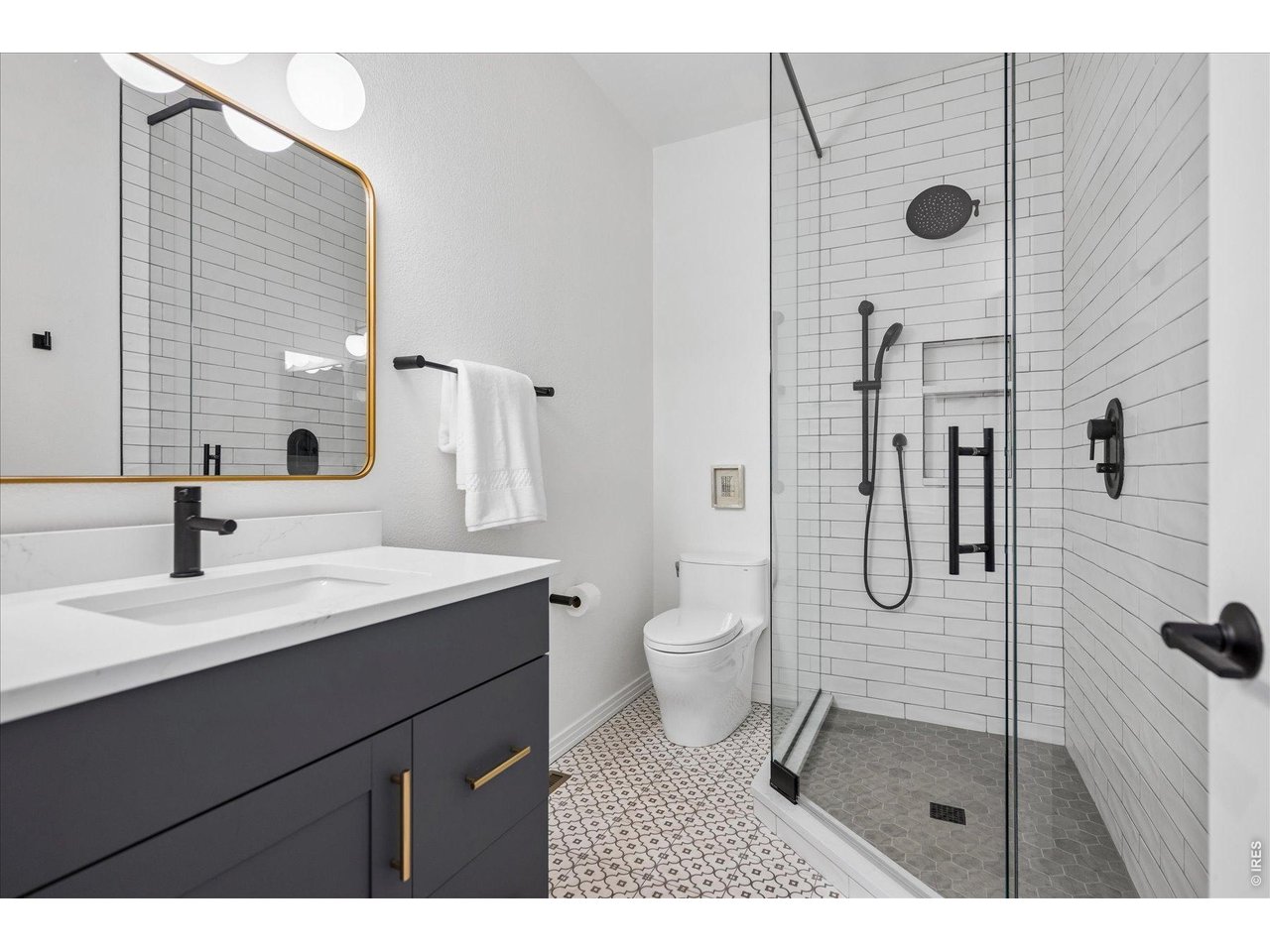 1424 Solitude Lane Evergreen, CO 80439 - Photo 26 of 46 a bathroom with a sink a toilet and shower