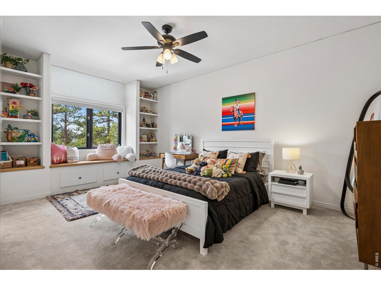 1424 Solitude Lane Evergreen, CO 80439 - Photo 27 of 46 a spacious bedroom with a bed a couch and a large window