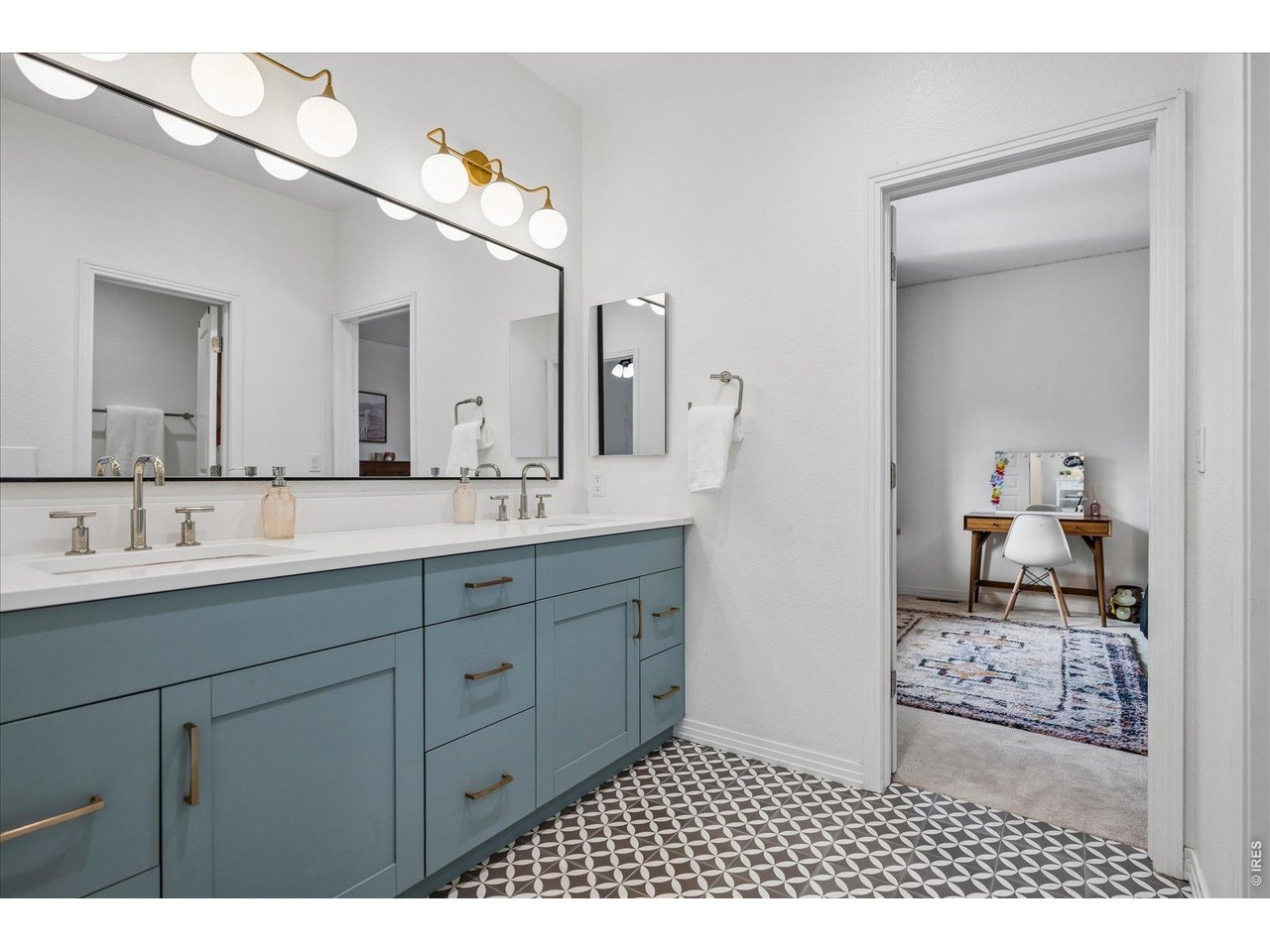1424 Solitude Lane Evergreen, CO 80439 - Photo 28 of 46 a bathroom with a sink a mirror and a toilet