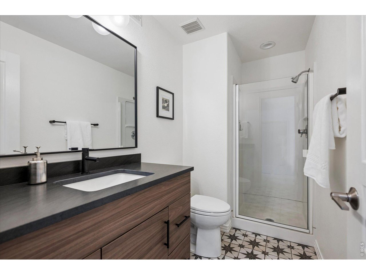 1424 Solitude Lane Evergreen, CO 80439 - Photo 33 of 46 a bathroom with a granite countertop sink mirror vanity and toilet