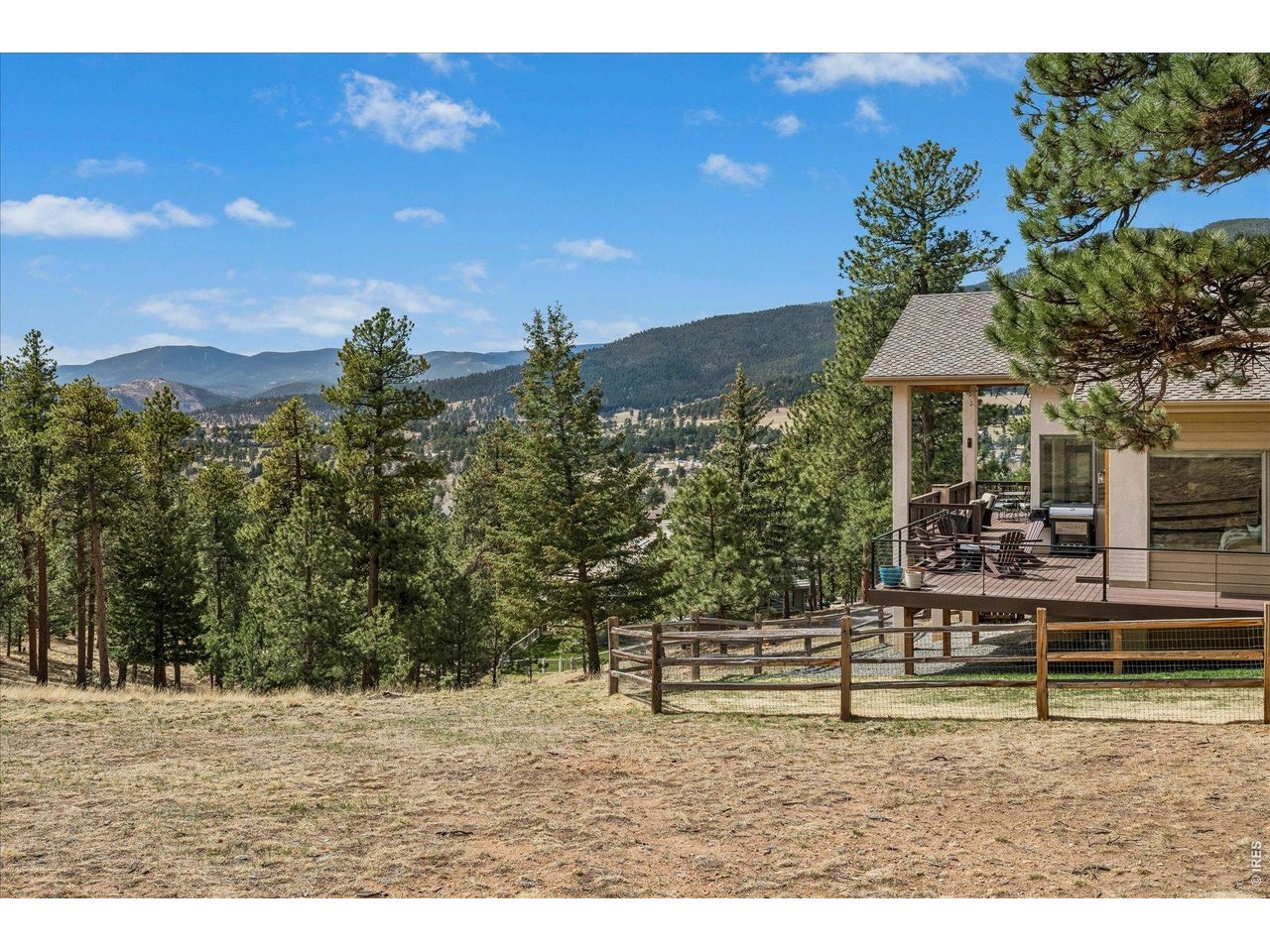 1424 Solitude Lane Evergreen, CO 80439 - Photo 37 of 46 a backyard of a house with table and chairs