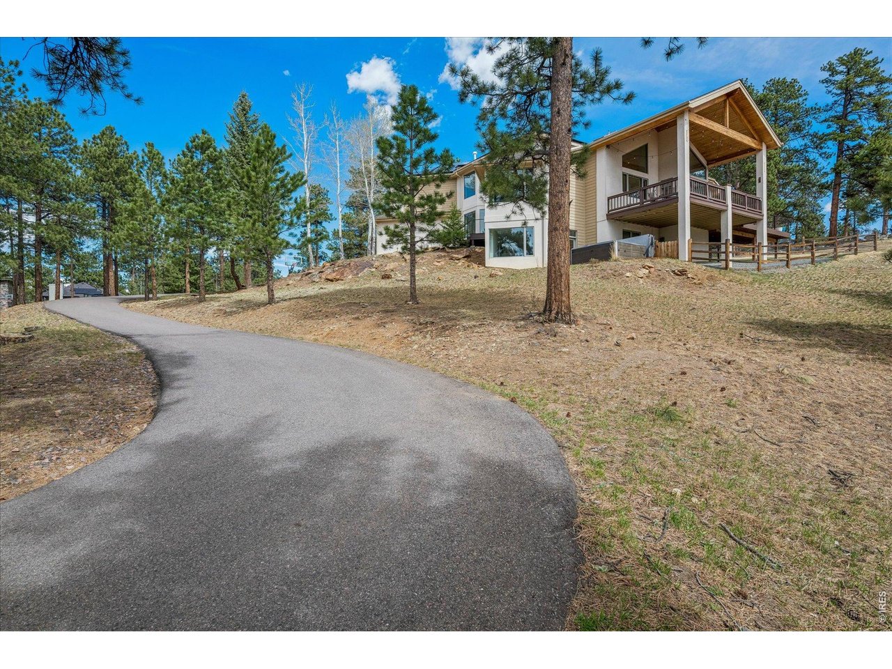 1424 Solitude Lane Evergreen, CO 80439 - Photo 39 of 46 a view of a house with a yard