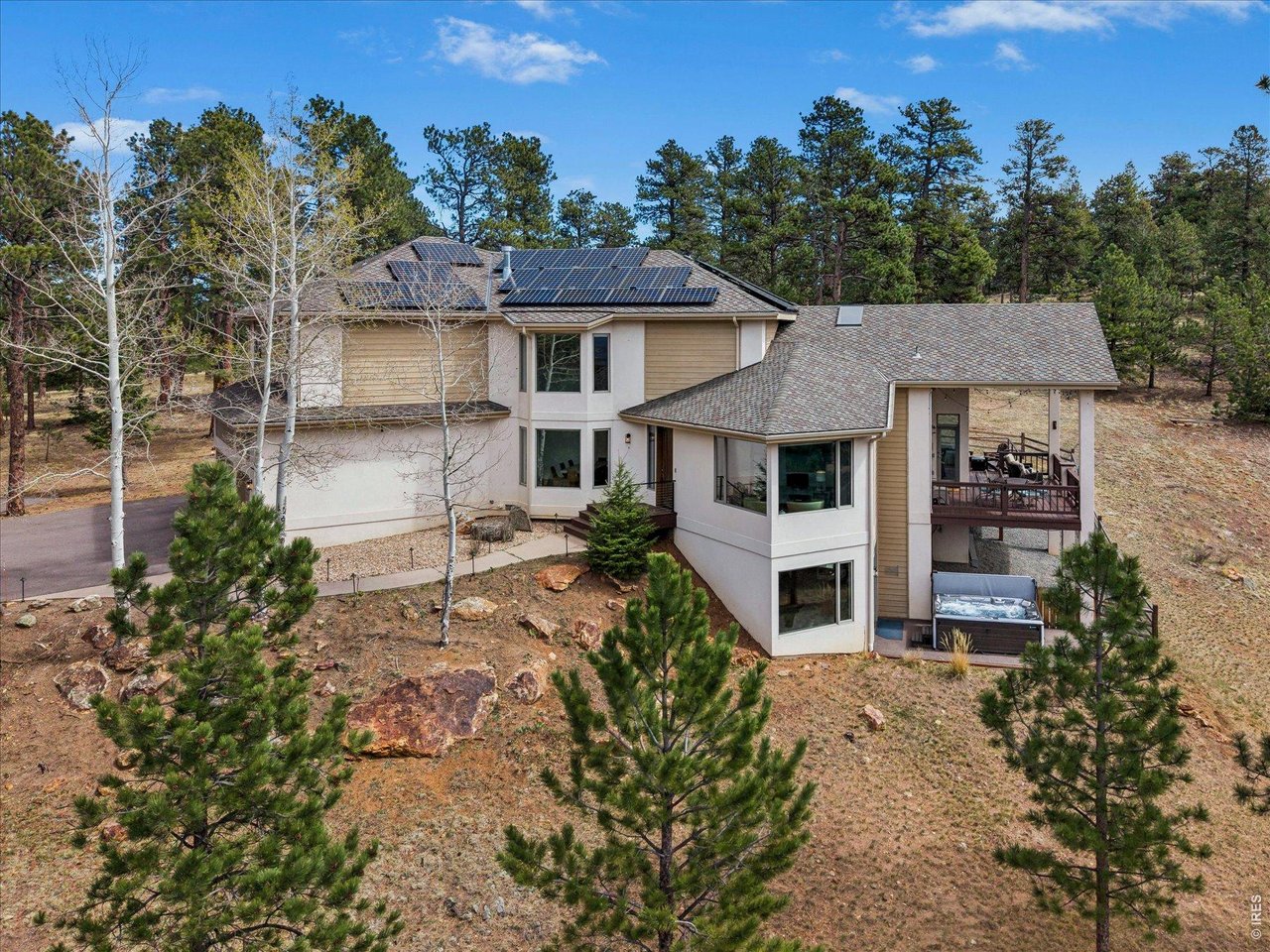 1424 Solitude Lane Evergreen, CO 80439 - Photo 40 of 46 front view of a house with a yard