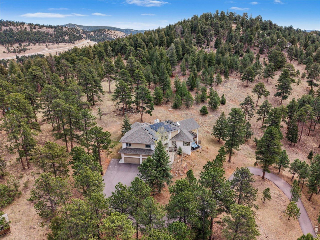 1424 Solitude Lane Evergreen, CO 80439 - Photo 43 of 46 an aerial view of a house with mountain view
