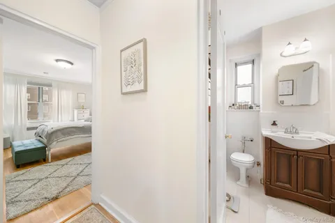 a spacious bathroom with a sink a toilet and a mirror