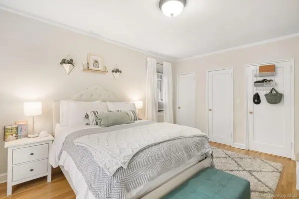 a bedroom with a bed and a painting on the wall