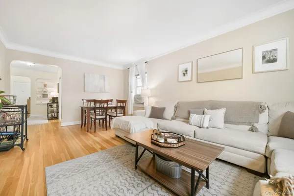 a living room with furniture dining table and a wooden floor