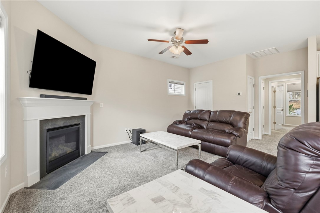 121 Wheaton Court Simpsonville, SC 29680 - Photo 11 of 40 This inviting living area features a fireplace, providing warmth and a focal point for gatherings.