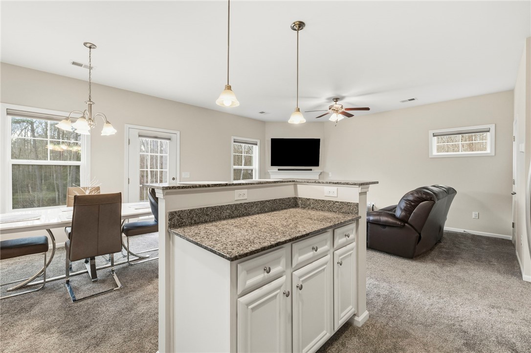 121 Wheaton Court Simpsonville, SC 29680 - Photo 16 of 40 This inviting space offers a seamless flow between kitchen and living areas, perfect for entertaining.