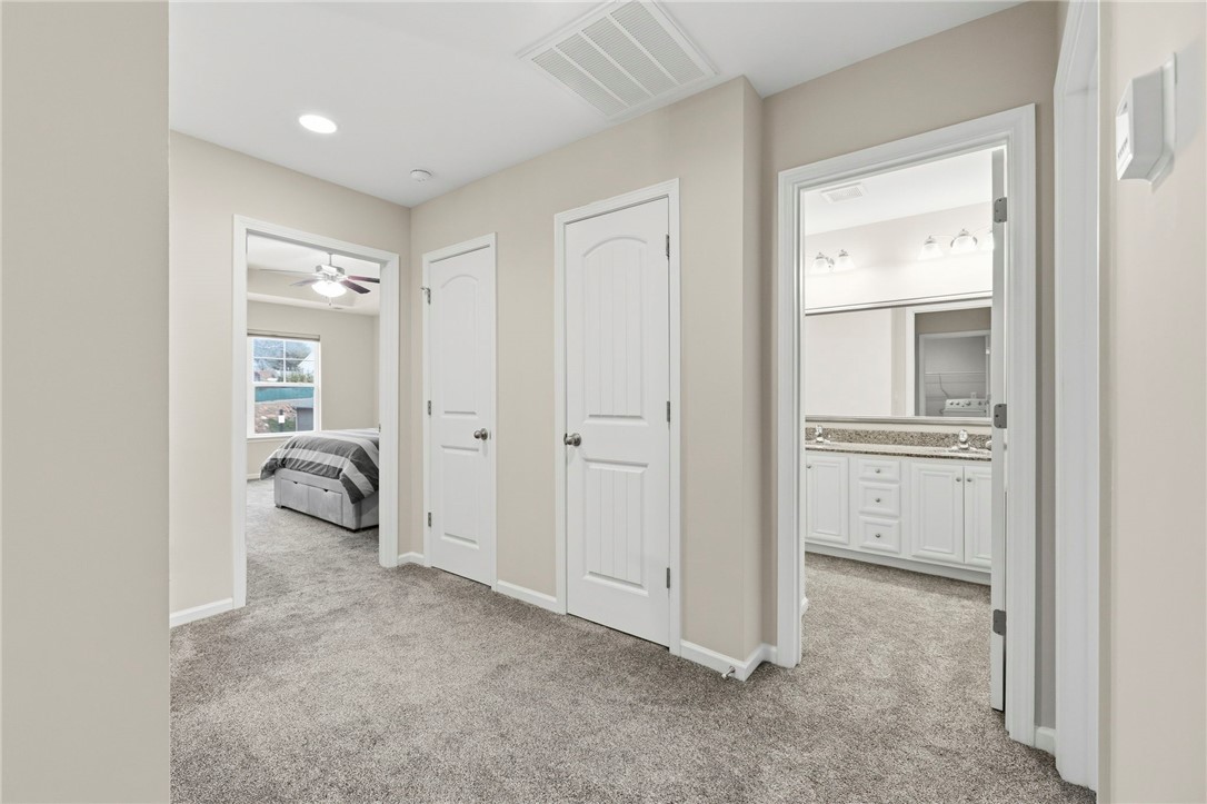 121 Wheaton Court Simpsonville, SC 29680 - Photo 22 of 40 This spacious hallway connects a comfortable bedroom and a pristine bathroom.