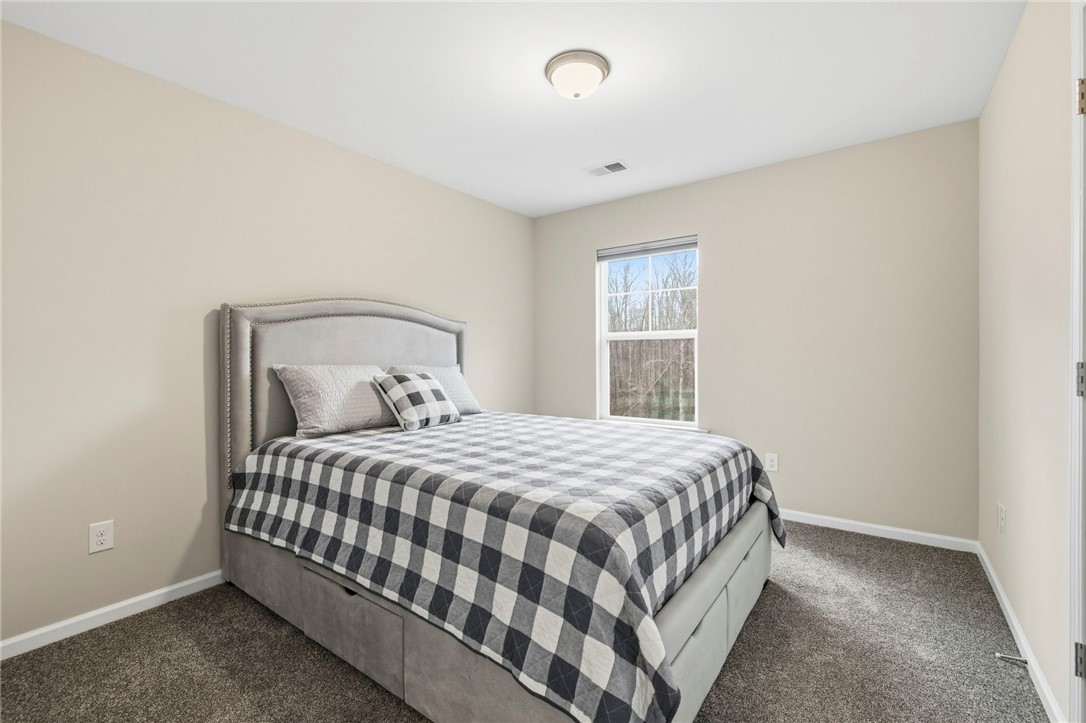 121 Wheaton Court Simpsonville, SC 29680 - Photo 27 of 40 This inviting bedroom features ample natural light and plush carpet for comfort.