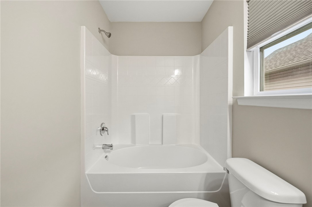 121 Wheaton Court Simpsonville, SC 29680 - Photo 31 of 40 This bathroom features a sleek bathtub with a shower, offering a serene escape.