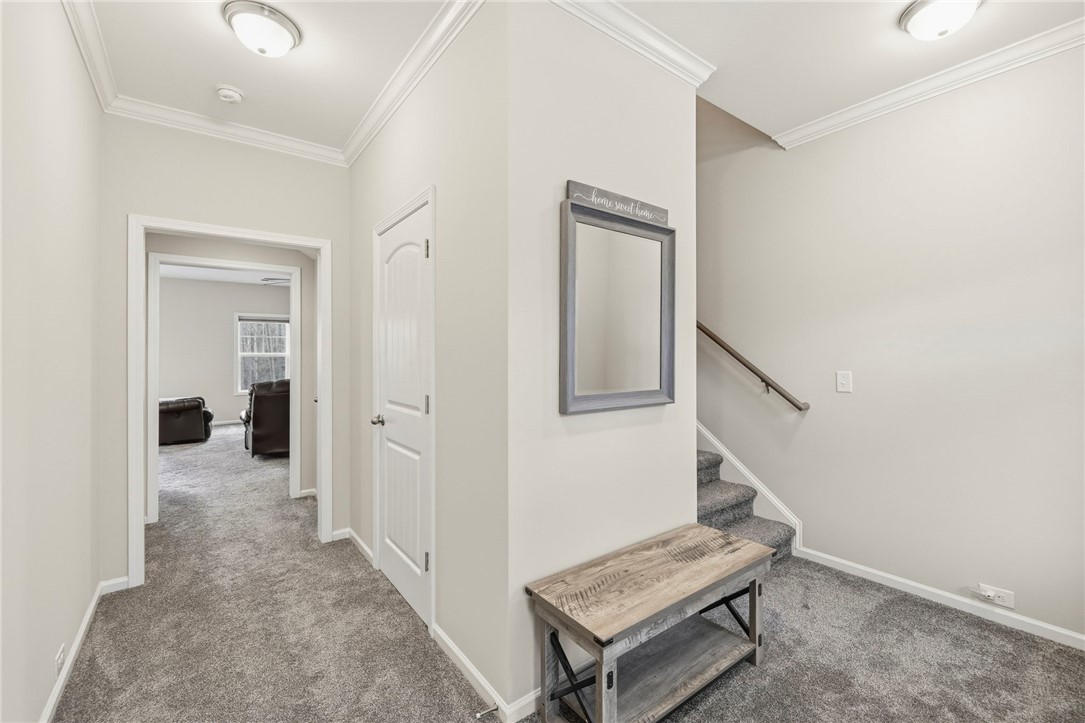 121 Wheaton Court Simpsonville, SC 29680 - Photo 7 of 40 This inviting entry features crown molding and leads to comfortable living spaces and a staircase.