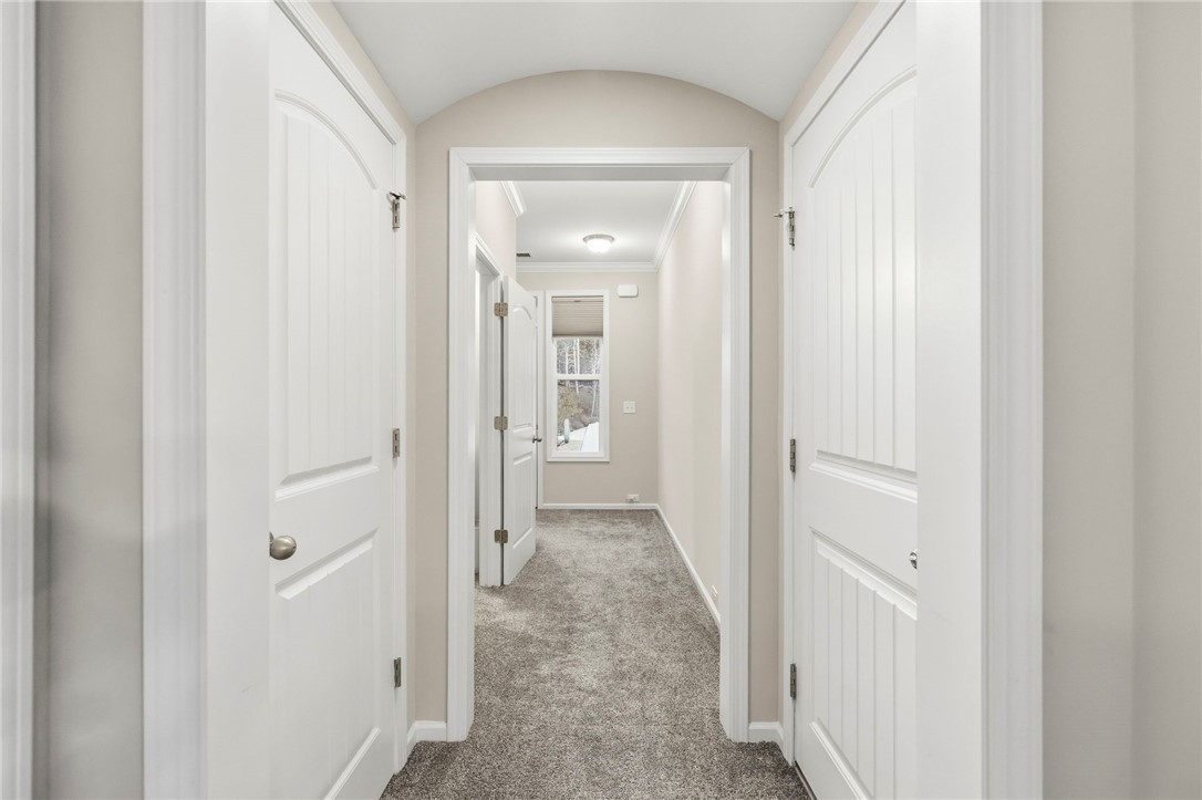 121 Wheaton Court Simpsonville, SC 29680 - Photo 9 of 40 This inviting hallway features soft carpeting and ample natural light, creating a bright atmosphere.