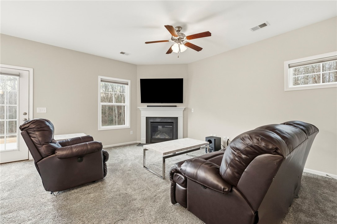 121 Wheaton Court Simpsonville, SC 29680 - Photo 10 of 40 This inviting living space features a cozy fireplace, perfect for relaxing evenings.