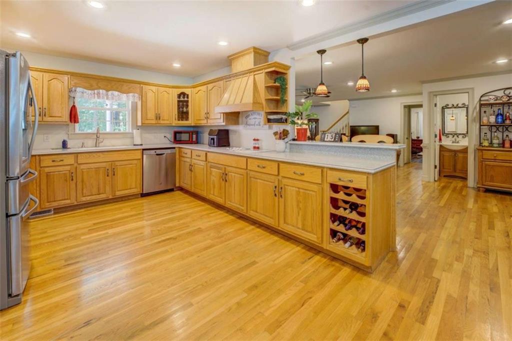 455 Bethany Road Covington, GA 30016 - Photo 13 of 39 a large kitchen with stainless steel appliances a sink and cabinets