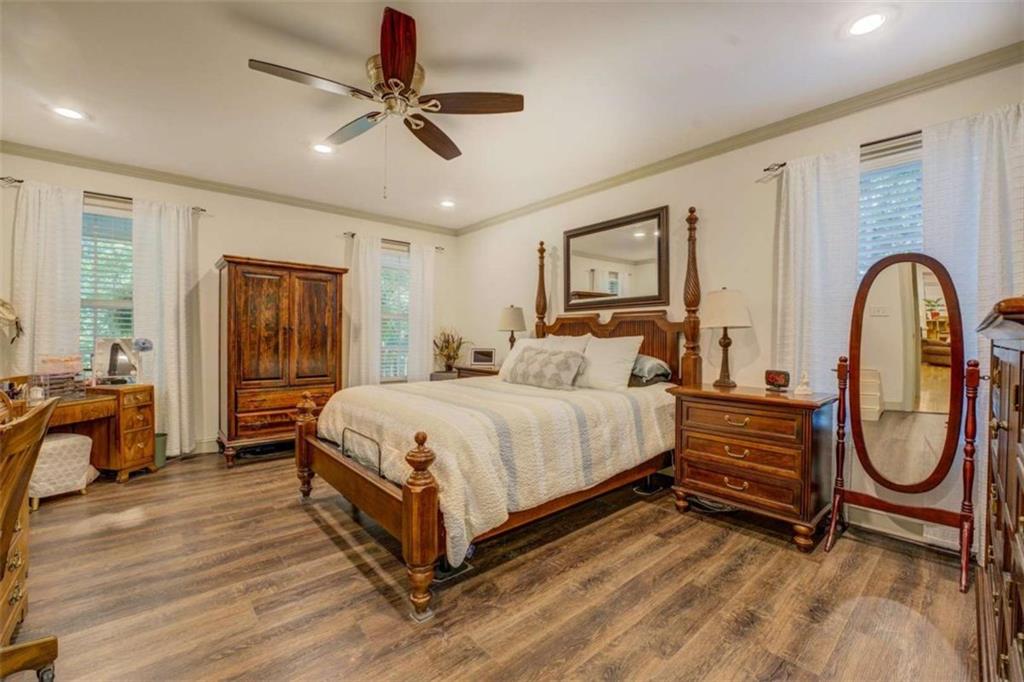 455 Bethany Road Covington, GA 30016 - Photo 16 of 39 a spacious bedroom with a bed a dresser and wooden floor