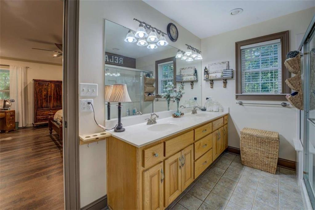 455 Bethany Road Covington, GA 30016 - Photo 18 of 39 a spacious bathroom with a double vanity sink a large mirror and shower