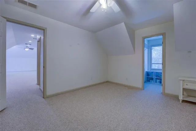 an empty room with closet and windows