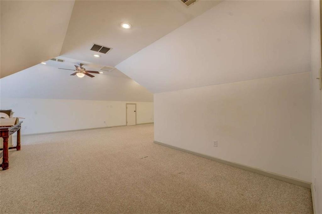 455 Bethany Road Covington, GA 30016 - Photo 26 of 39 an empty room with a projector and cabinets