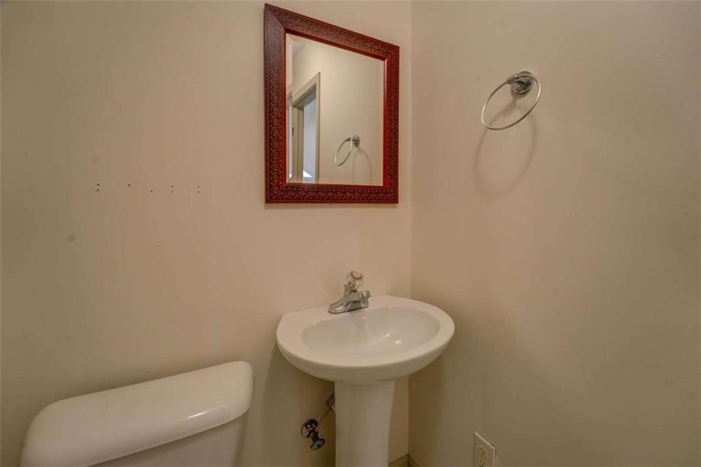 455 Bethany Road Covington, GA 30016 - Photo 28 of 39 a bathroom with a toilet sink and mirror