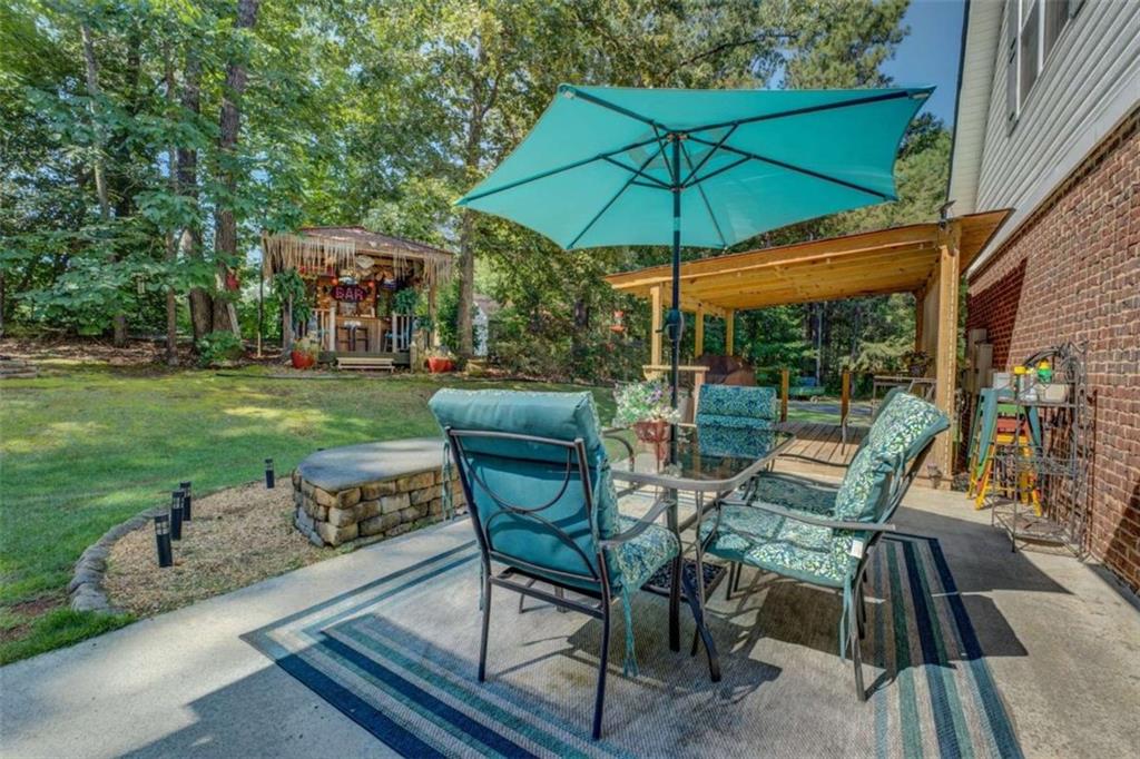 455 Bethany Road Covington, GA 30016 - Photo 29 of 39 a view of a patio with table and chairs under an umbrella