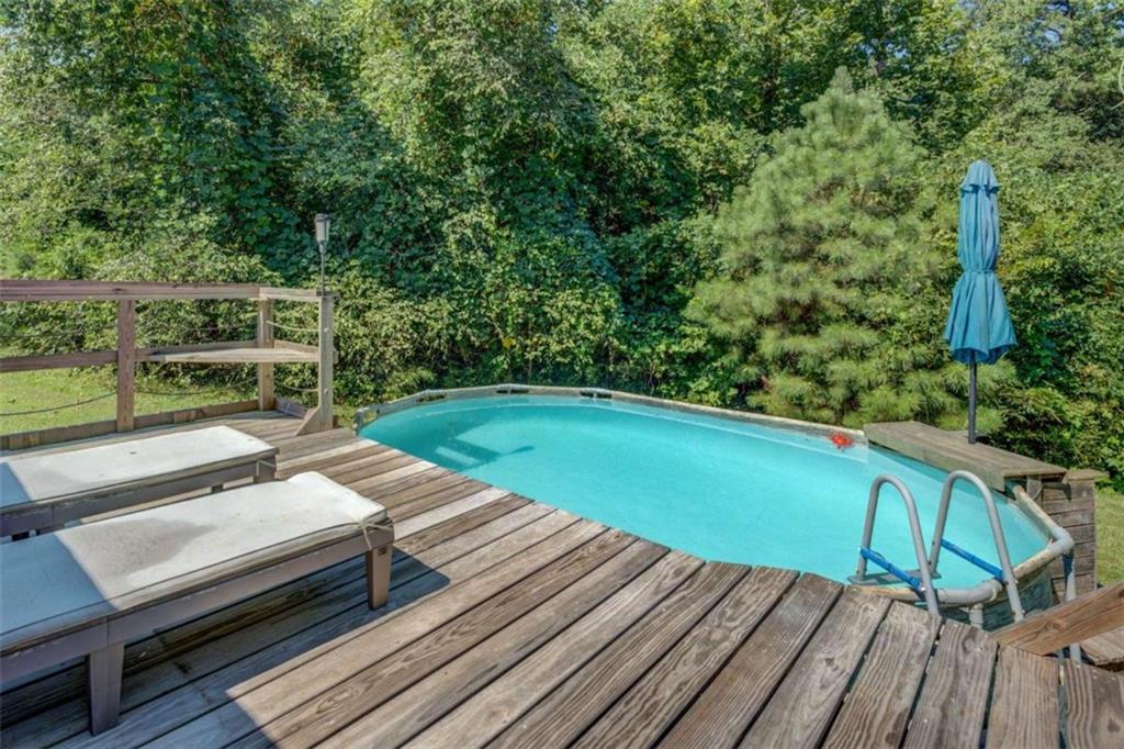 455 Bethany Road Covington, GA 30016 - Photo 36 of 39 a view of a wooden deck with a bench