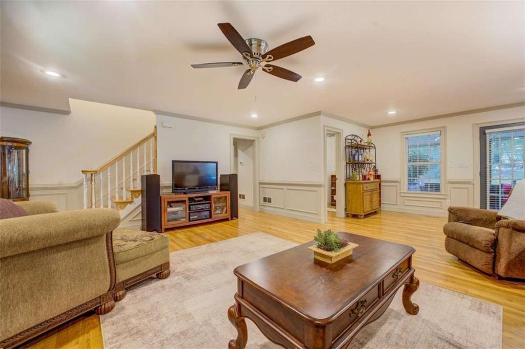 455 Bethany Road Covington, GA 30016 - Photo 9 of 39 a living room with furniture and a dining table with wooden floor
