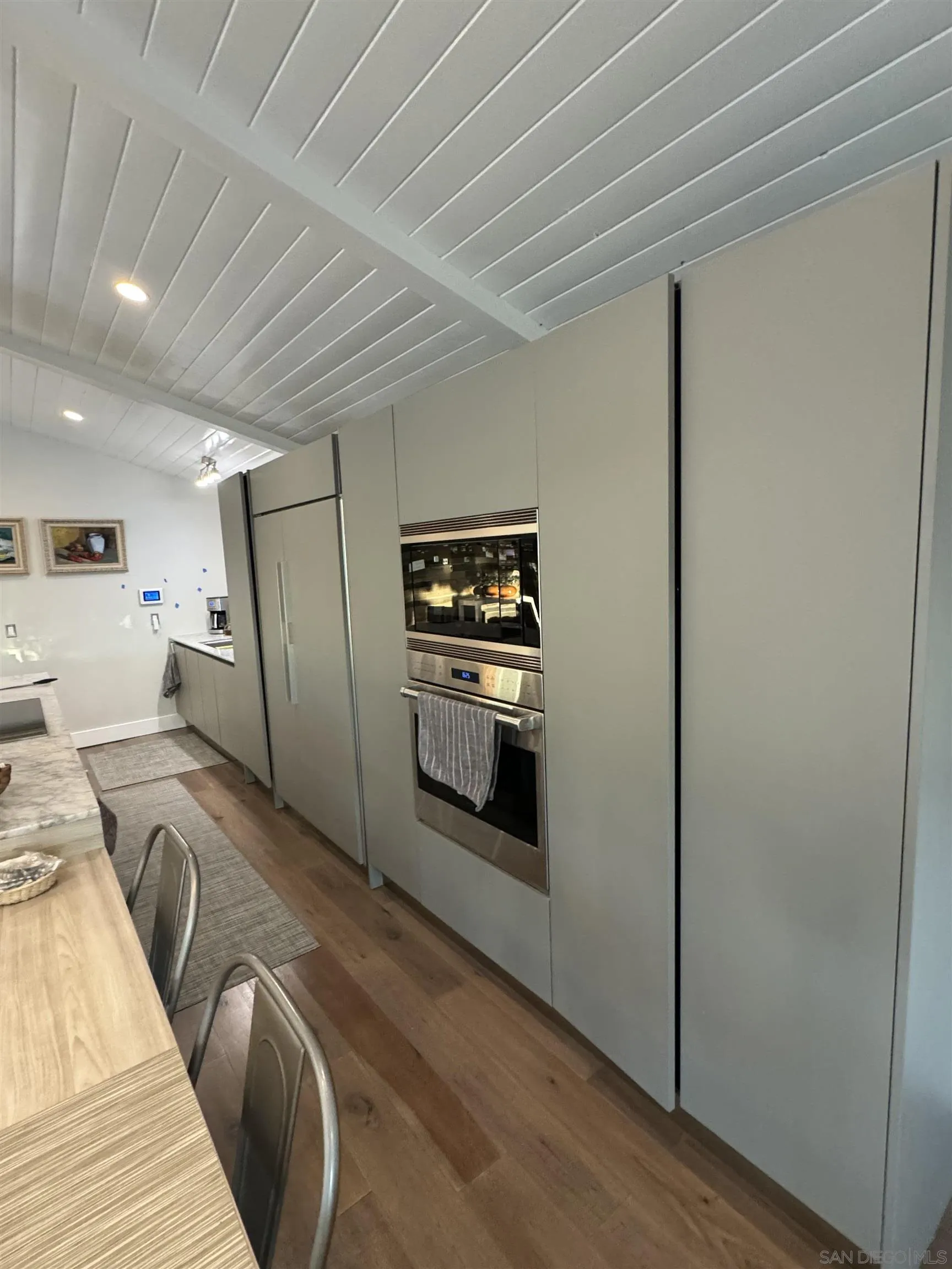 1402 Rodeo Drive La Jolla, CA 92037 - Photo 39 of 62 a kitchen with stainless steel appliances granite countertop a refrigerator and a stove
