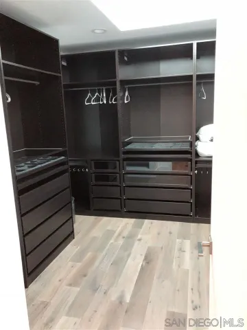 a bedroom with a bed and a television