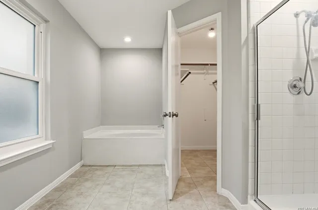 a bathroom with a bathtub and a shower