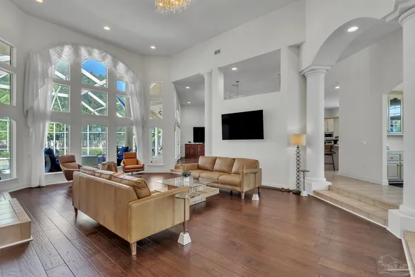 a spacious bedroom with a bed and a chandelier