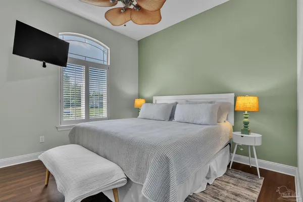 a bedroom with a bed and wooden floor