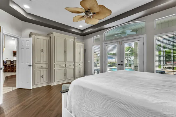 a bedroom with a bed and wooden floor