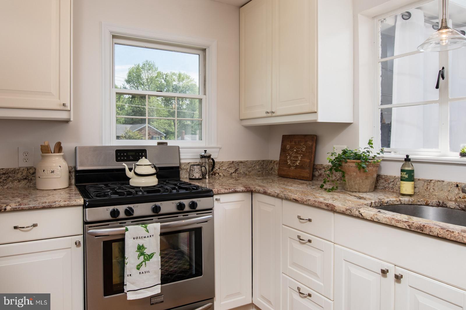 2101 Shenandoah Road Alexandria, VA 22308 - Photo 16 of 44 a kitchen with granite countertop white cabinets white appliances and a granite counter tops