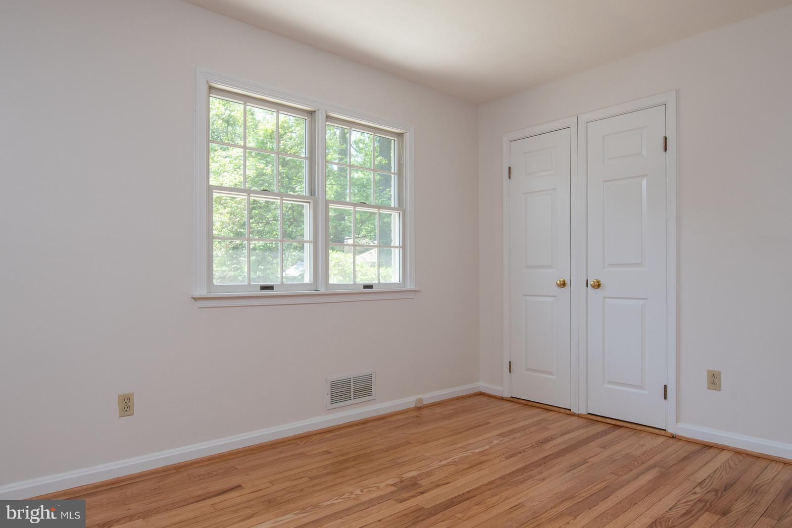 2101 Shenandoah Road Alexandria, VA 22308 - Photo 17 of 44 a view of an empty room with wooden floor and a window