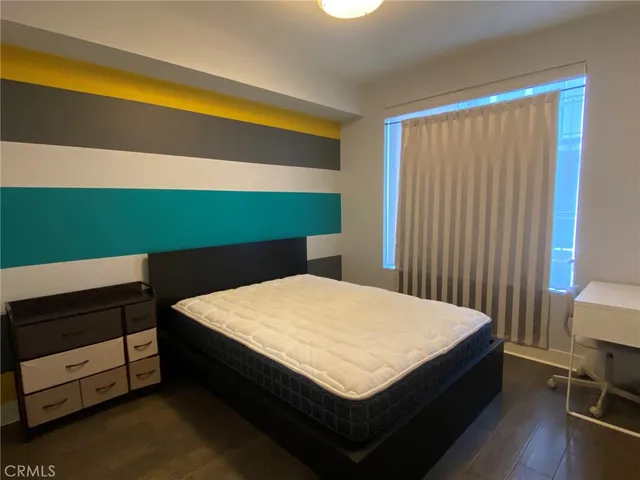 a bed sitting in a bedroom next to a window