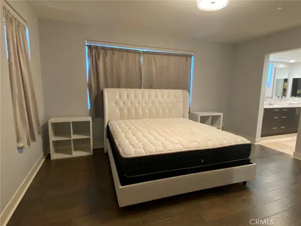 a bed sitting in a bedroom next to a window