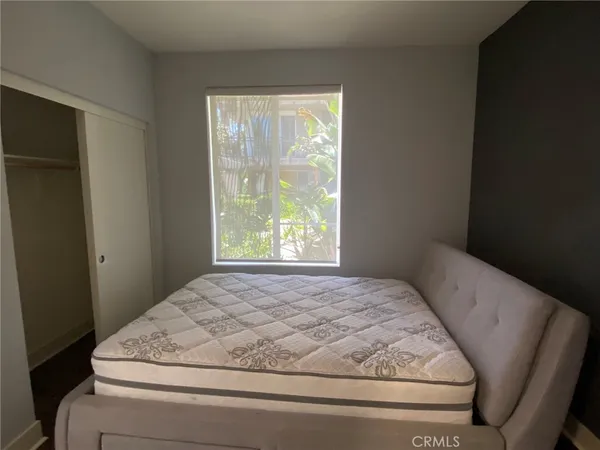 a bedroom with a bed and window