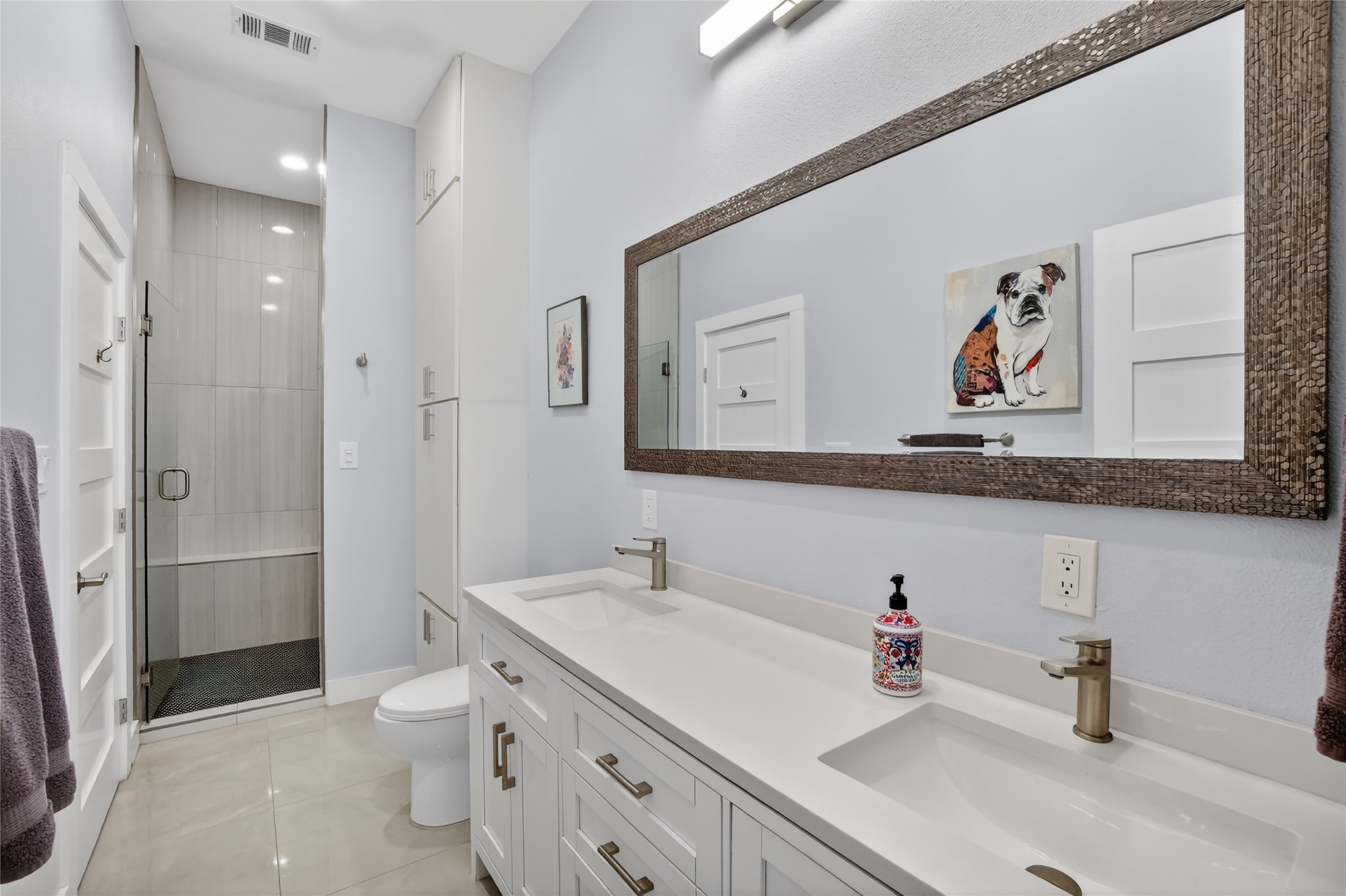 3627 Stoneridge Road Austin, TX 78746 - Photo 29 of 40 Bathroom with a shower stall, double vanity, and light tile patterned floors
